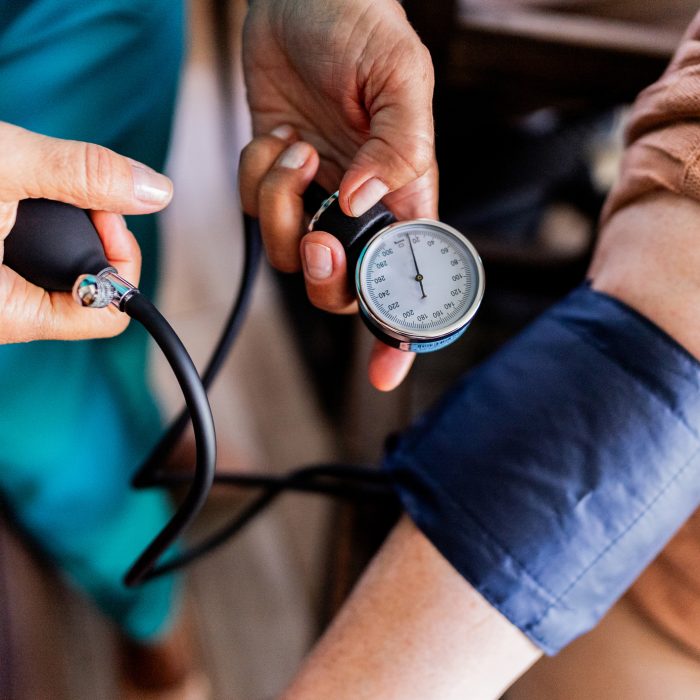 Caregiver measuring patient's blood pressure